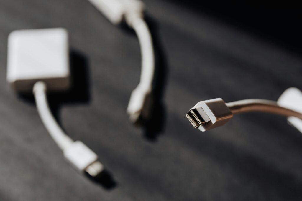 Macro photo showcasing close-up of USB cables and connectors on dark surface.